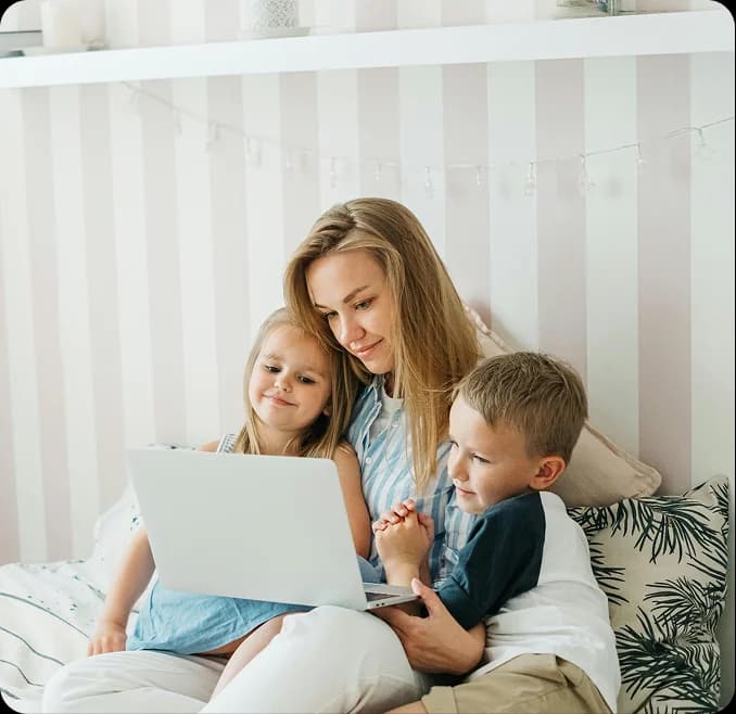 Mother and children looking at laptop together